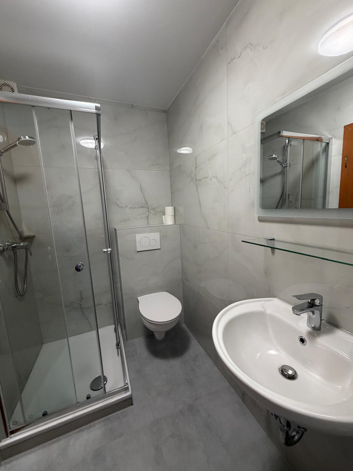 Modern bathroom with glass shower and round washbasin at Hotel Weller Riedstadt